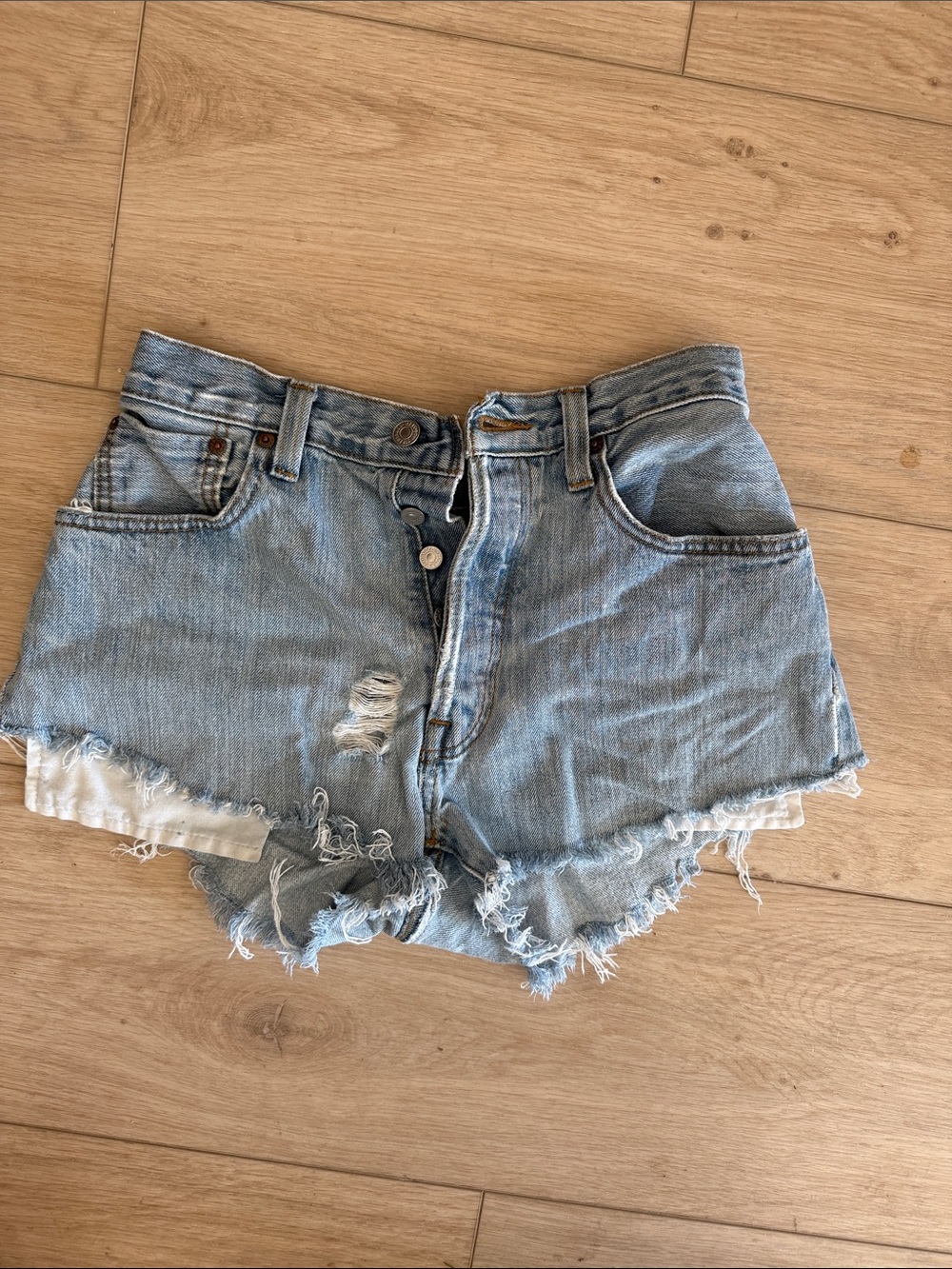 Vintage Levi's light blue distressed denim shorts with button fly